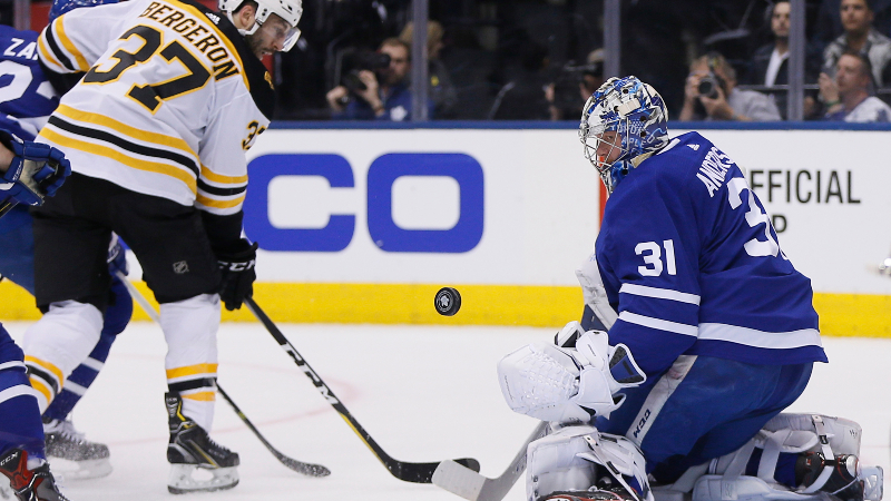 Boston Bruins forward Patrice Bergeron (left) and Toronto Maple Leafs goaltender Frederik Andersen