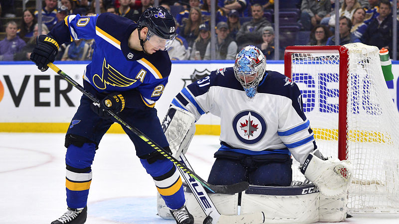 Winnipeg Jets goaltender Connor Hellebuyck (37) and St. Louis Blues left wing Alexander Steen (20)