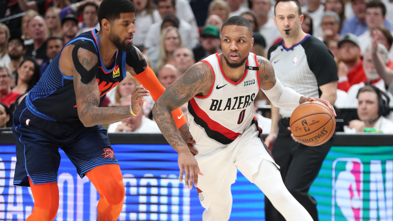 Portland Trail Blazers guard Damian Lillard (0) and Oklahoma City Thunder forward Paul George (13)