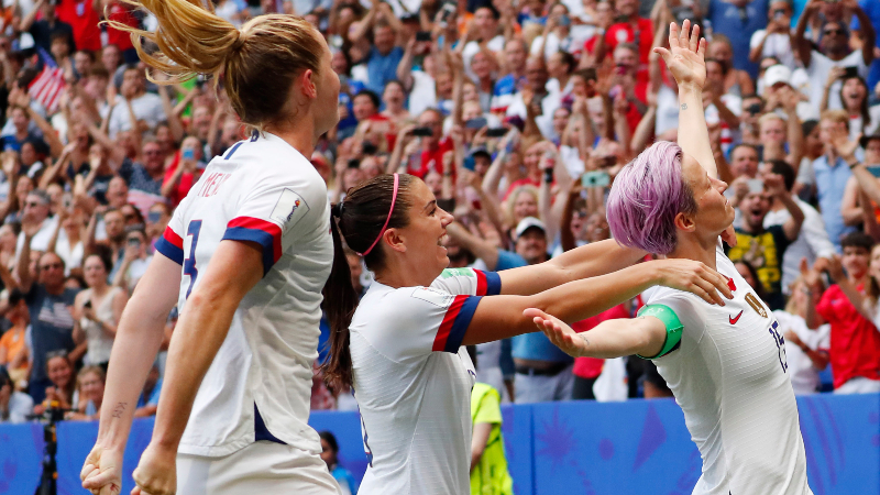 United States forward Megan Rapinoe (15) and teammates Tobin Heath (left) and Alex Morgan (center)