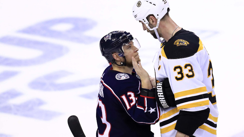 Boston Bruins defenseman Zdeno Chara (33) and Columbus Blue Jackets right wing Cam Atkinson (13)