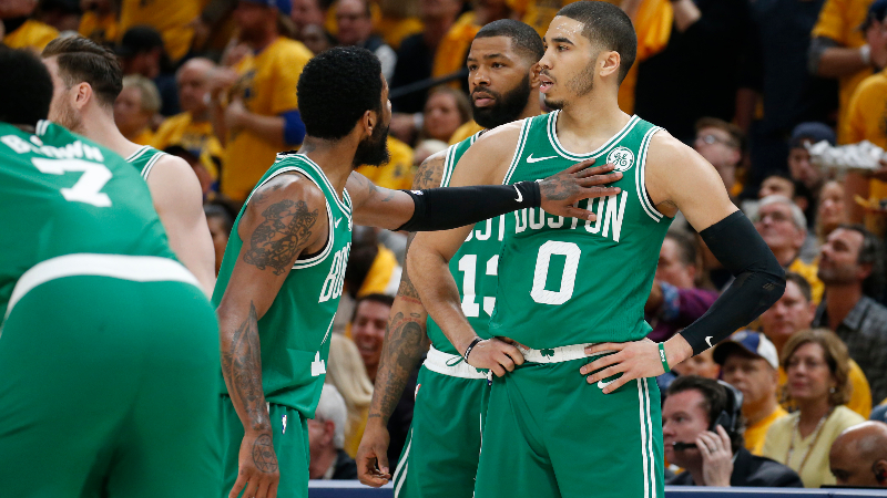 Boston Celtics forward Jayson Tatum (0), former guard Kyrie Irving (11) and former forward Marcus Morris (13)