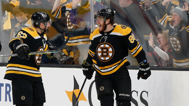 Boston Bruins right wing David Pastrnak (88) and left wing Brad Marchand (63)