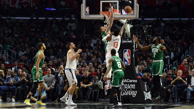 Los Angeles Clippers forward Paul George (13) and Boston Celtics forward Daniel Theis (27)