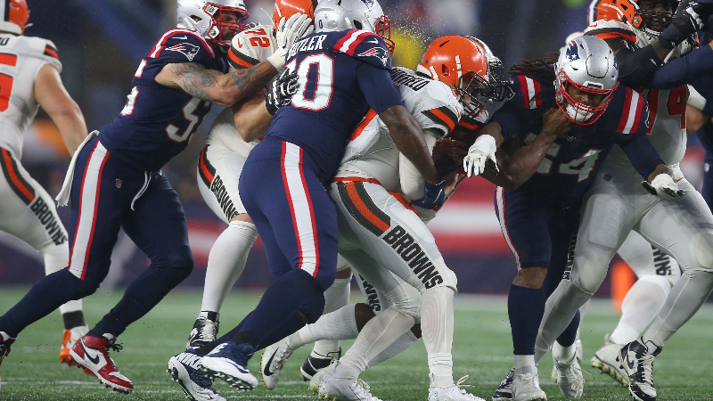 New England Patriots defensive lineman Adam Butler (70) and Cleveland Browns quarterback Baker Mayfield (6)