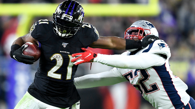 Baltimore Ravens running back Mark Ingram (21) and New England Patriots outside linebacker Elandon Roberts (52)
