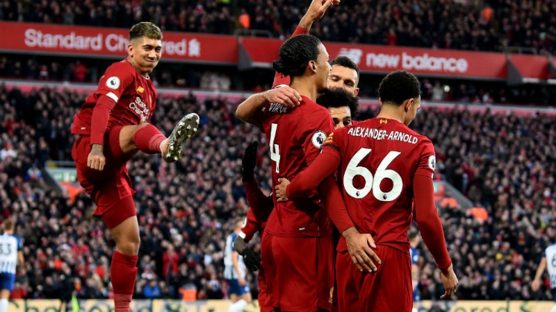 Liverpool forward Roberto Firmino (left) and defenders Virgil van Dijk (center) and Trent Alexander-Arnold (right)