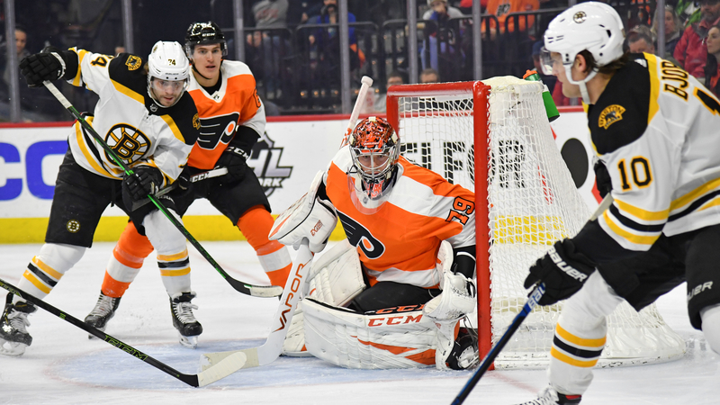 Boston Bruins' Anders Bjork and Jake DeBrusk And Philadelphia Flyers' Carter Hart