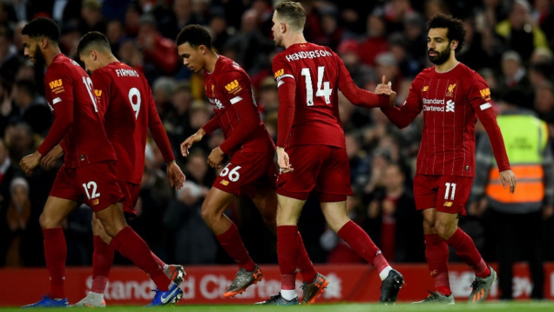 Liverpool midfielder Jordan Henderson (14), forward Mohamed Salah (left) and teammates