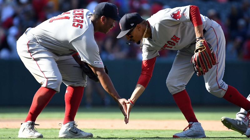 Boston Red Sox third baseman Rafael Devers (11) and right fielder Mookie Betts (50)