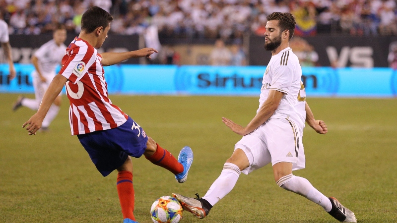 Atletico Madrid's Juan Manuel Sanabria (left) and Real Madrid's Nacho Fernandez