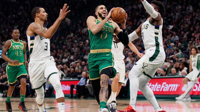 Boston Celtics forward Jayson Tatum (0) and Milwaukee Bucks guards George Hill (3) and Wesley Matthews (9)