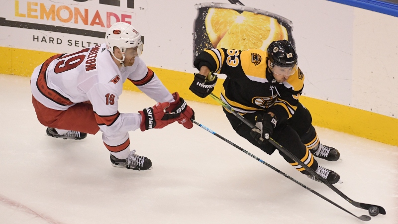 Boston Bruins left wing Brad Marchand (63) and Carolina Hurricanes defenseman Dougie Hamilton (19)