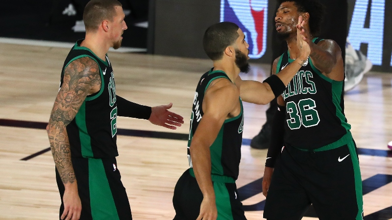 Boston Celtics center Daniel Theis (left), forward Jayson Tatum (center) and guard Marcus Smart