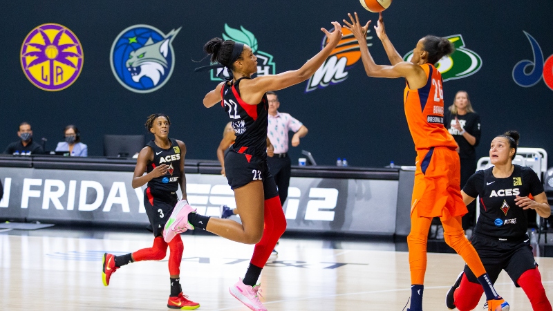 Las Vegas Aces center A'ja Wilson (22) and Connecticut Sun forward DeWanna Bonner (24)