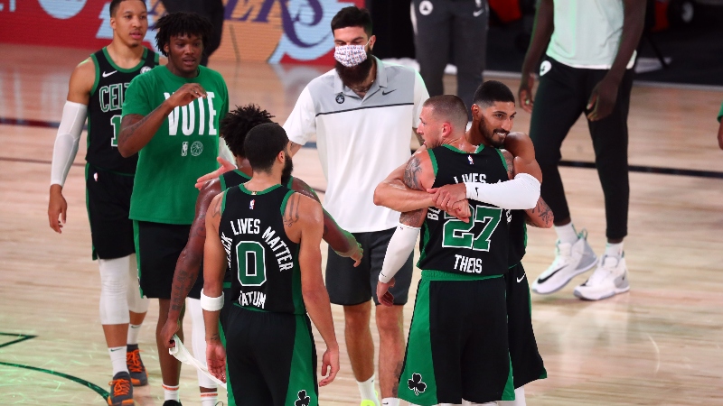 Boston Celtics forward Jayson Tatum (0), center Daniel Theis (27) and teammates