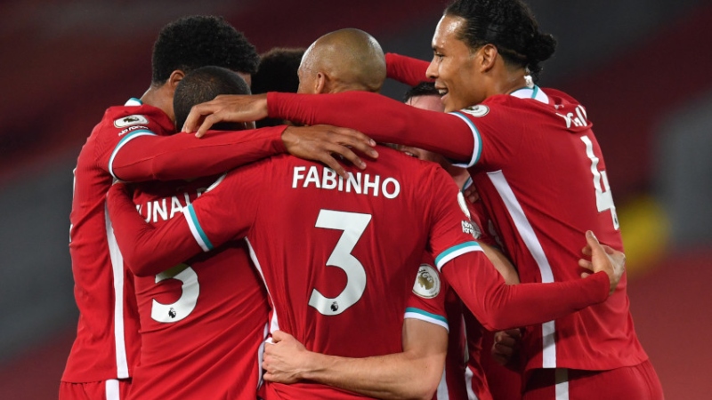 Liverpool midfielder Fabinho (center), defender Virgil van Dijk (right) and teammates