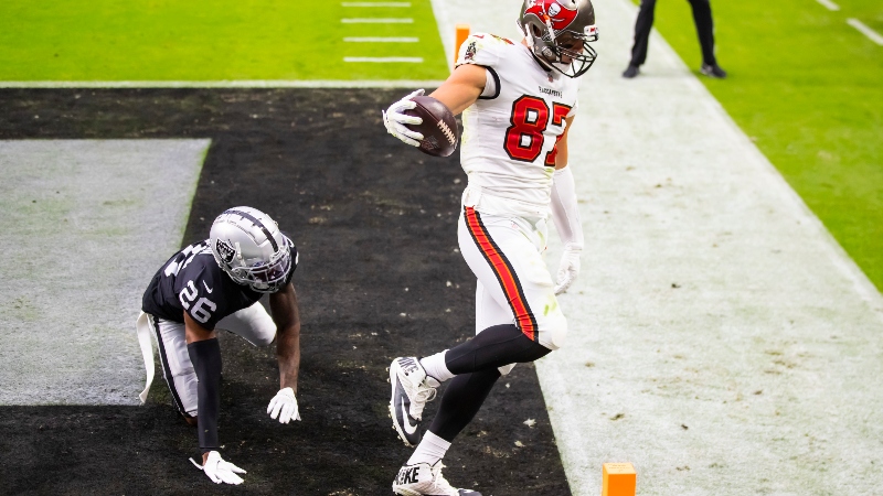 Tampa Bay Buccaneers tight end Rob Gronkowski (right) and Las Vegas Raiders cornerback Nevin Lawson