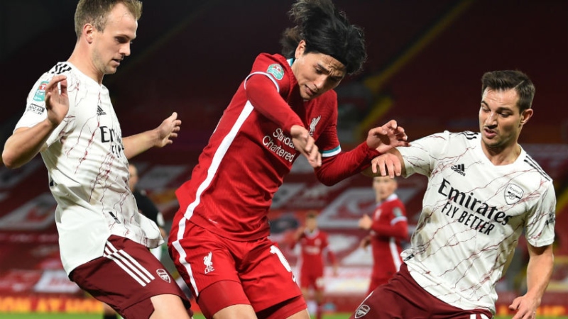 Liverpool midfielder Takumi Minamino and Arsenal defenders Rob Holding (left) and Cedric Soares (right)