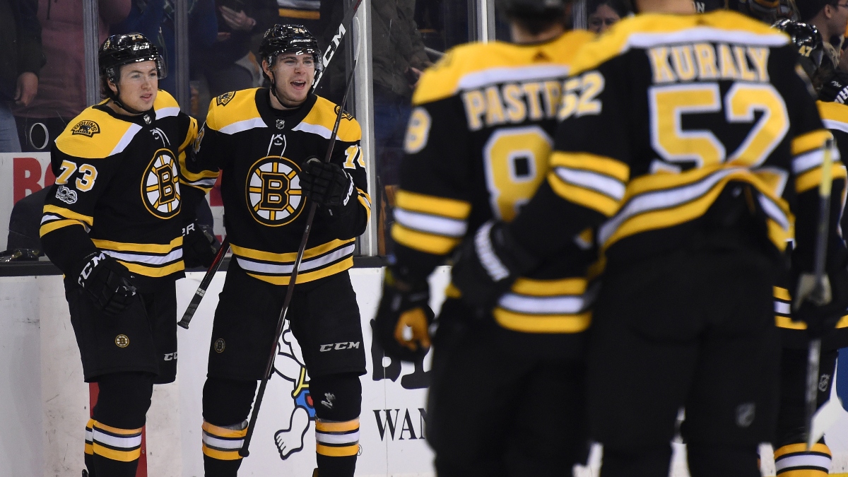 Boston Bruins left wing Jake DeBrusk (74) and defenseman Charlie McAvoy (73)