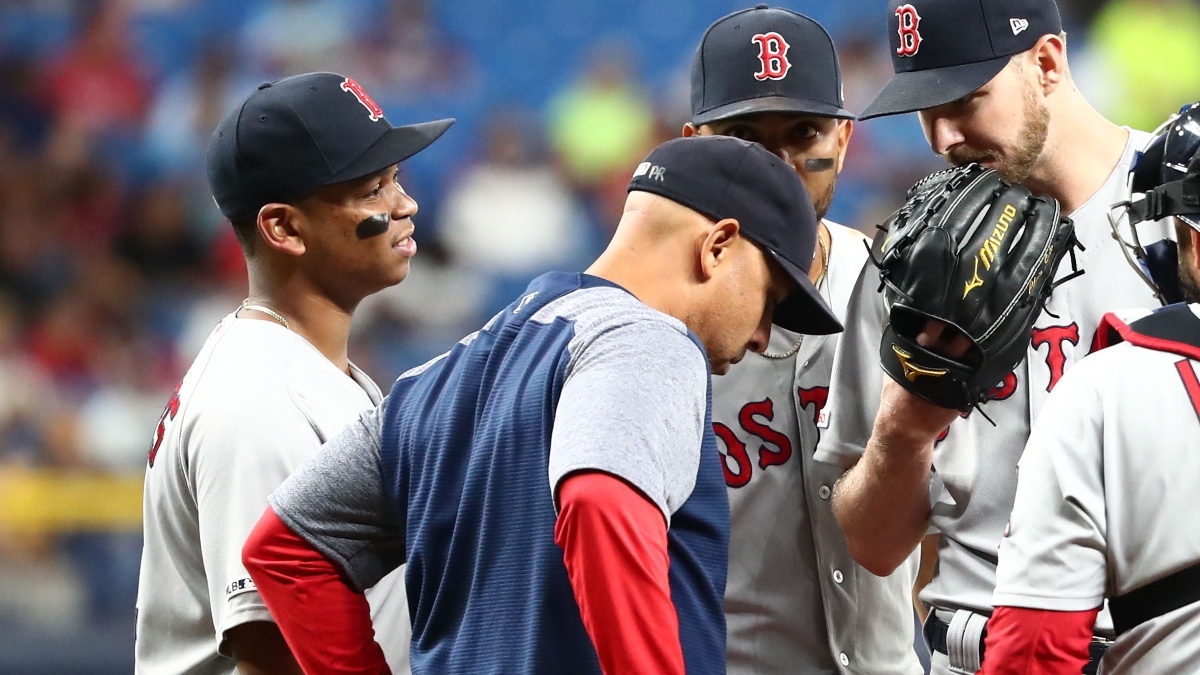 Boston Red Sox manager Alex Cora (front), third baseman Rafael Devers (left) and pitcher Chris Sale (right)