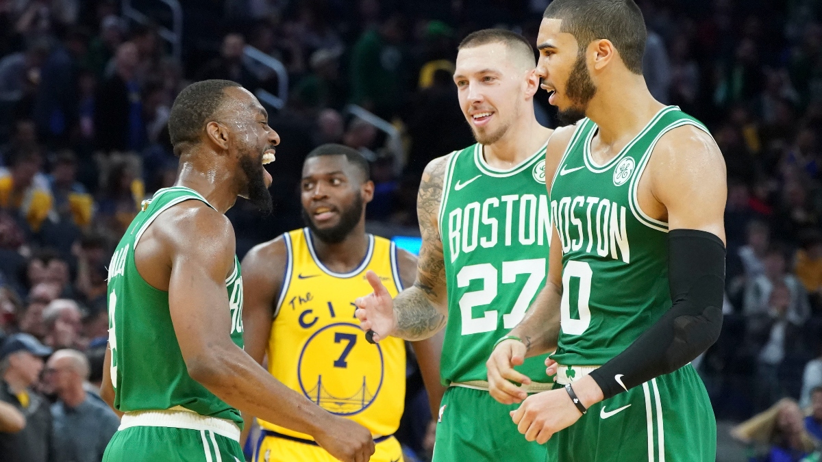 Boston Celtics guard Kemba Walker (right), Center Daniel Theis (27) and forward Jayson Tatum (0)