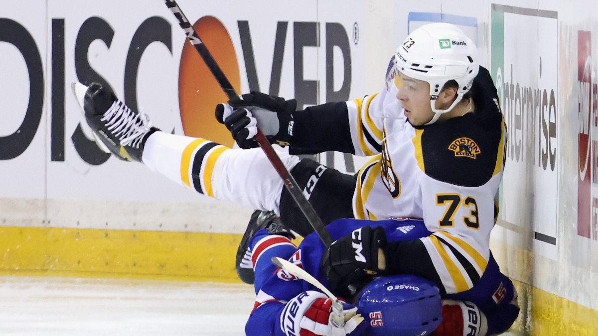 Boston Bruins defenseman Charlie McAvoy and New York Rangers defenseman Ryan Lindgren