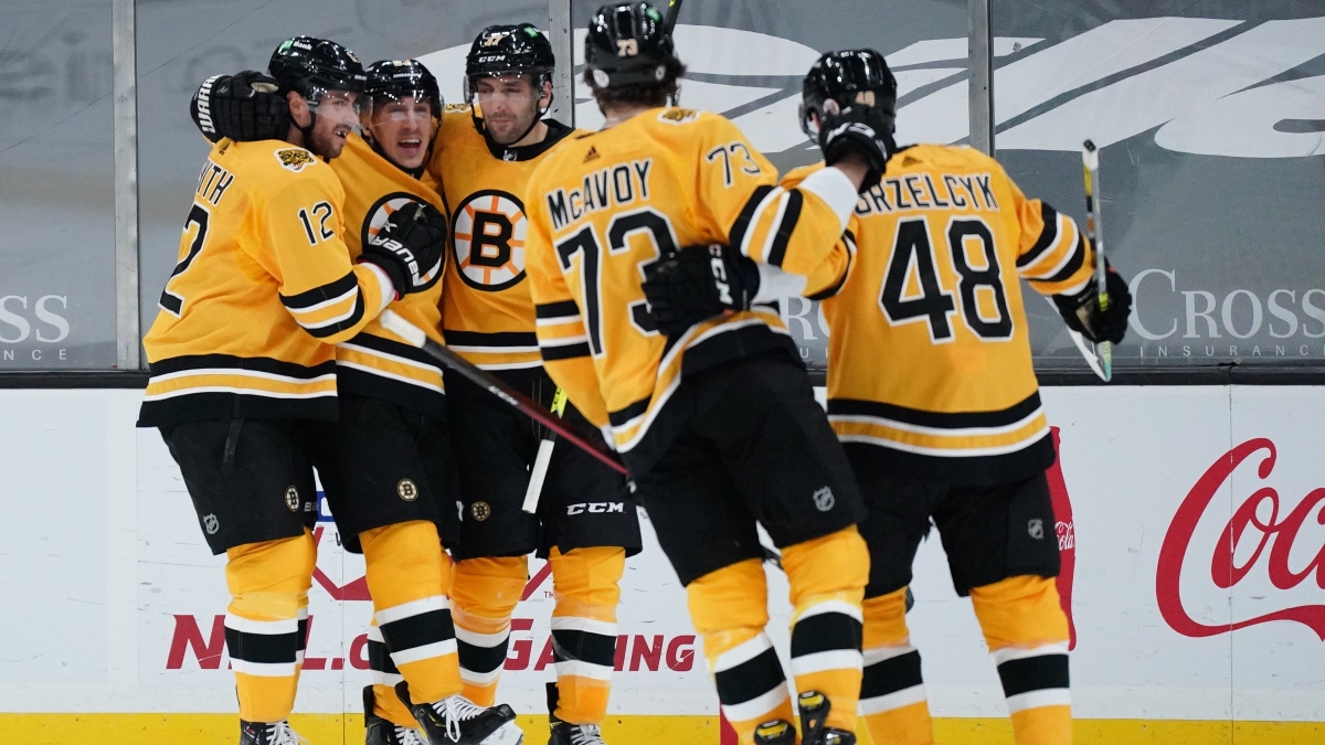 Boston Bruins left wing Boston Bruins center Brad Marchand (63) and teammates