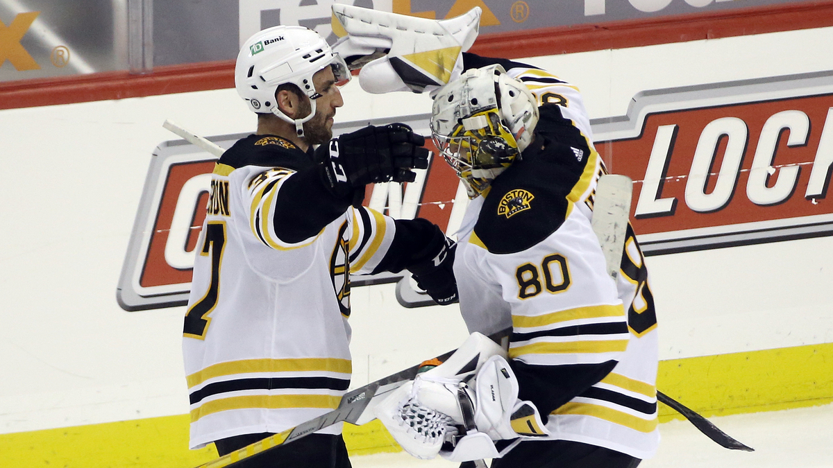 Boston Bruins goalie Dan Vladar, center Patrice Bergeron
