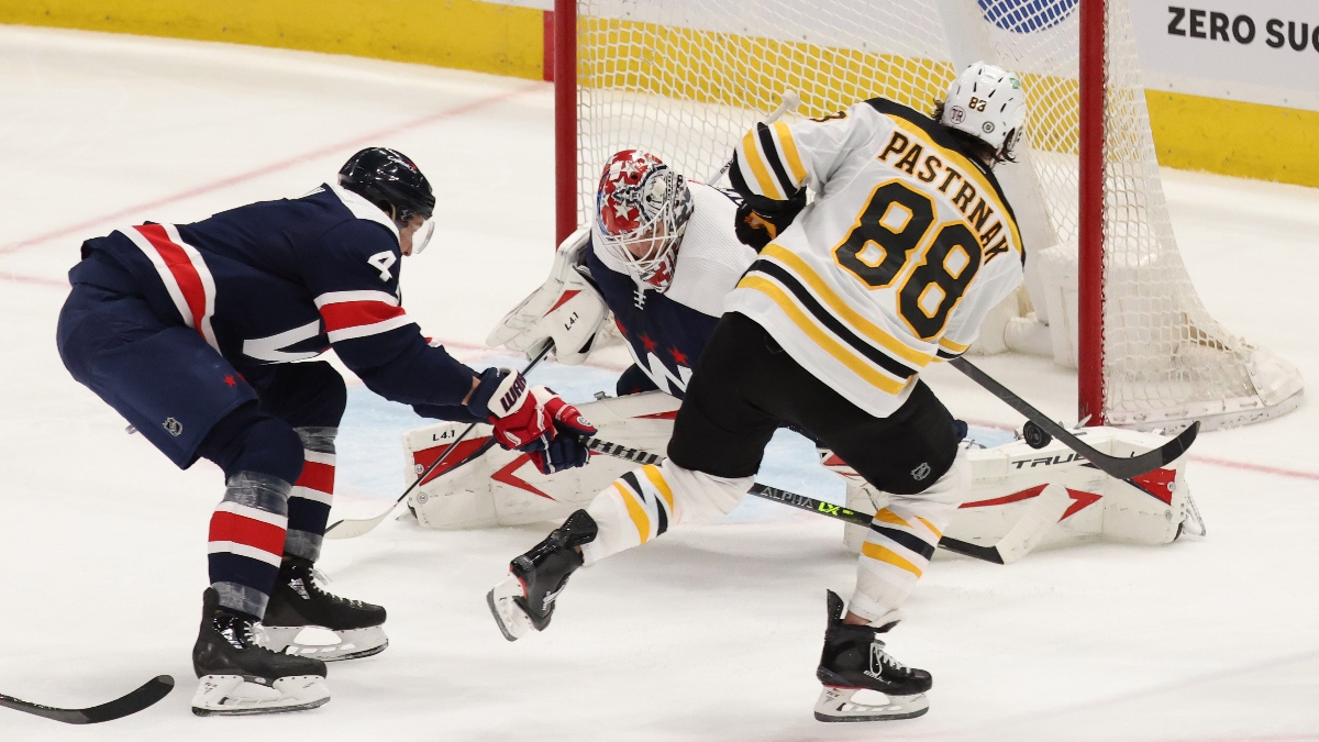 Boston Bruins right wing David Pastrnak and Washington Capitals goaltender Ilya Samsonov (30)