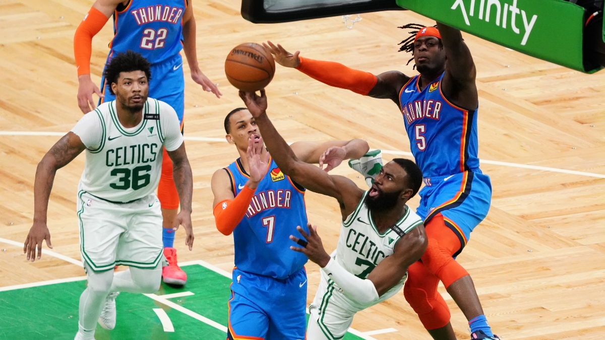 Oklahoma City Thunder forward Luguentz Dort (5) and forward Darius Bazley (7) and Boston Celtics guard Jaylen Brown (7)
