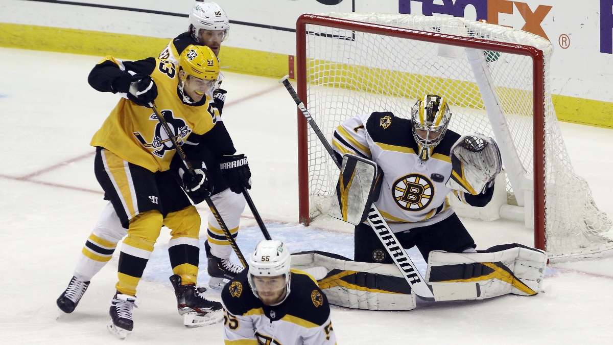Boston Bruins goaltender Jeremy Swayman and defenseman Kevan Miller (86) and Pittsburgh Penguins center Teddy Blueger (53)