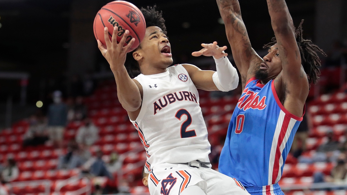 Auburn Tigers guard Sharife Cooper (2) and Mississippi Rebels forward Romello White (0)