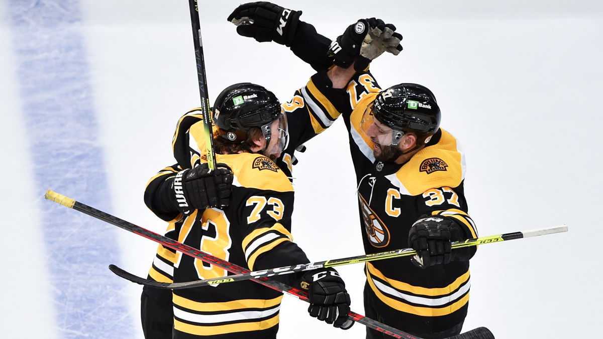 Boston Bruins defenseman Charlie McAvoy and center Patrice Bergeron