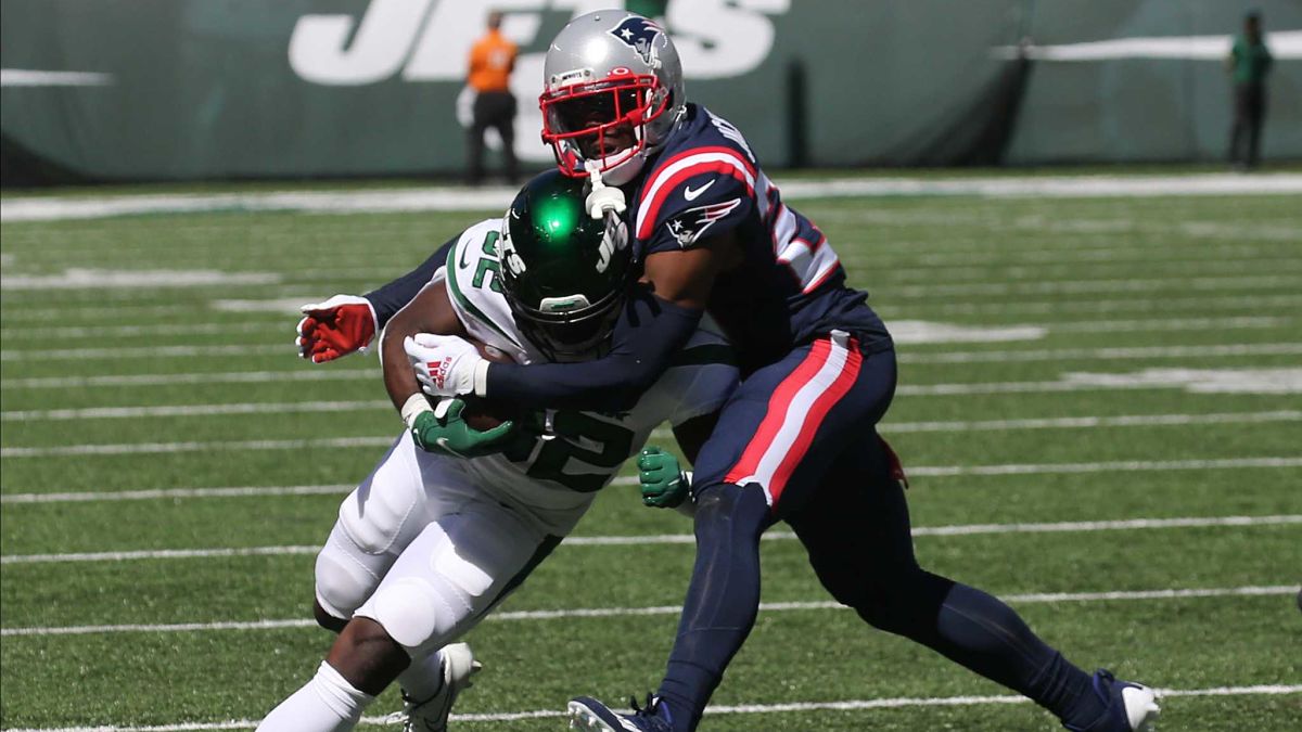 New York Jets running back Michael Carter and New England Patriots cornerback J.C. Jackson