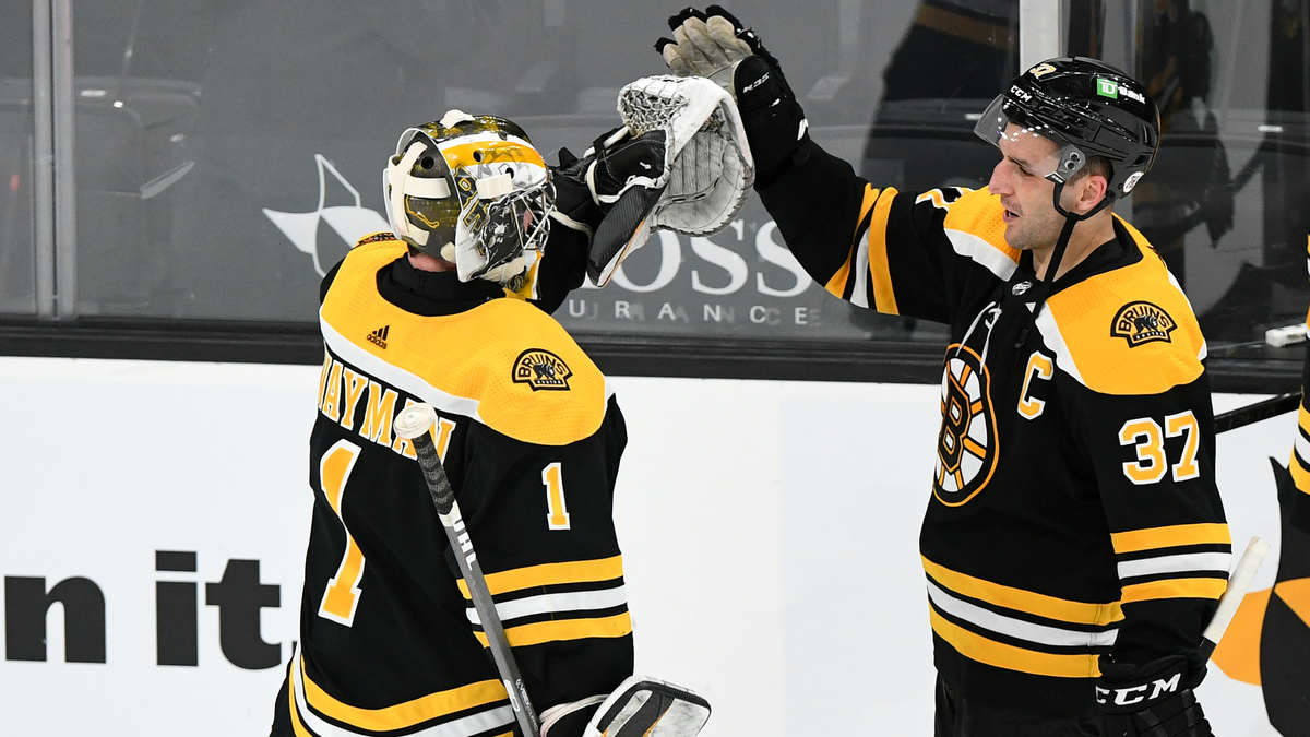 Boston Bruins goalie Jeremy Swayman, center Patrice Bergeron