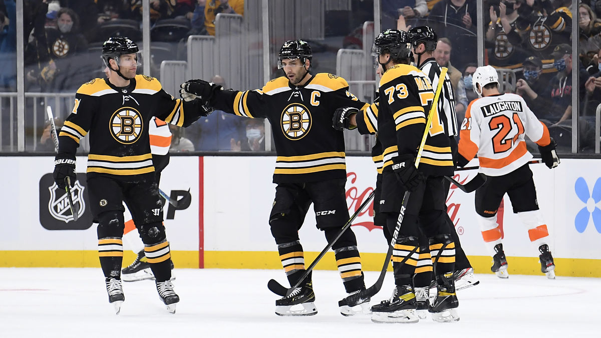 Boston Bruins center Patrice Bergeron, left wing Taylor Hall, defenseman Charlie McAvoy