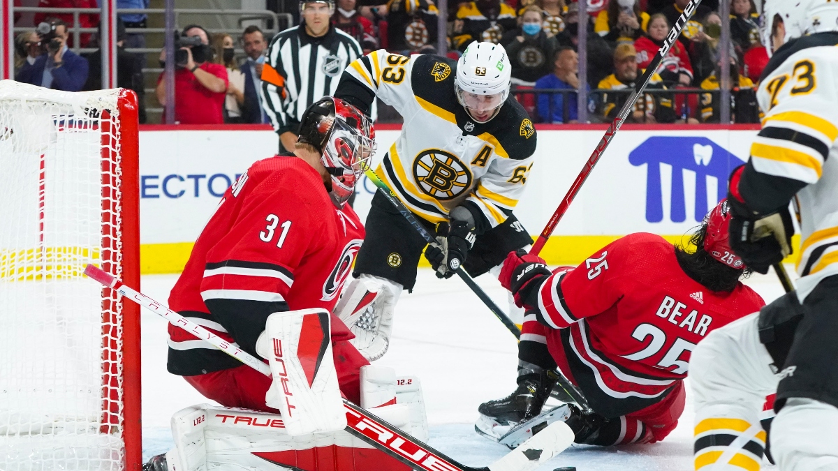 Carolina Hurricanes goaltender Frederik Andersen (31) and defenseman Ethan Bear (25) and Boston Bruins center left wing Brad Marchand (63)