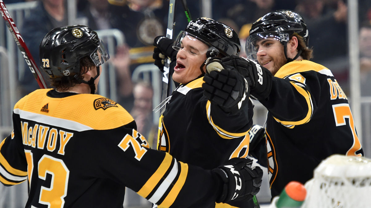 Charlie McAvoy, Karson Kuhlman and Jake DeBrusk of the Boston Bruins