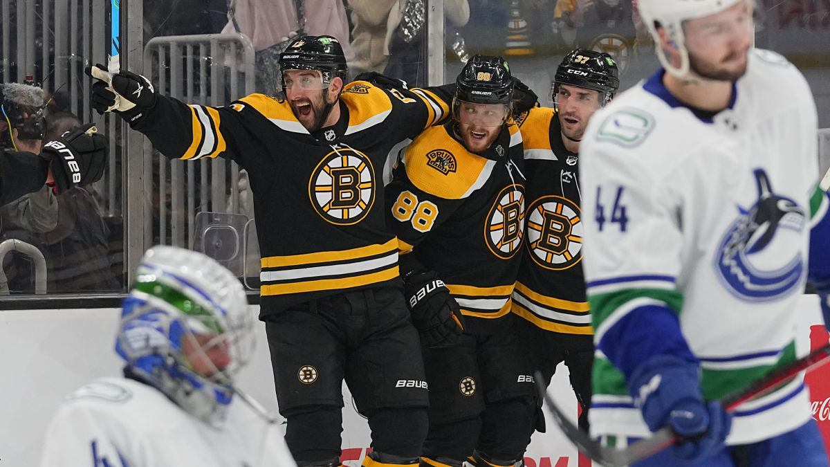 Boston Bruins forwards Nick Foligno, Brad David Pastrnak, and Patrice Bergeron