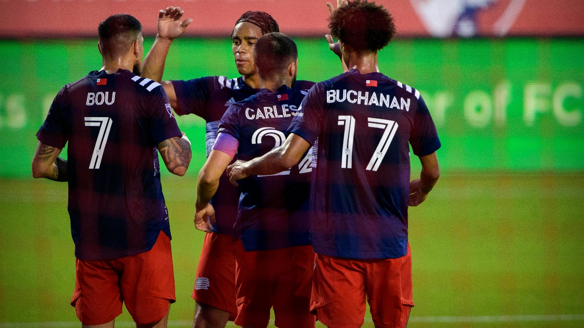 New England Revolution forward Gustavo Bou (7) and midfielder Carles Gil (22) and forward Tajon Buchanan (17) and midfielder Brandon Bye (15)