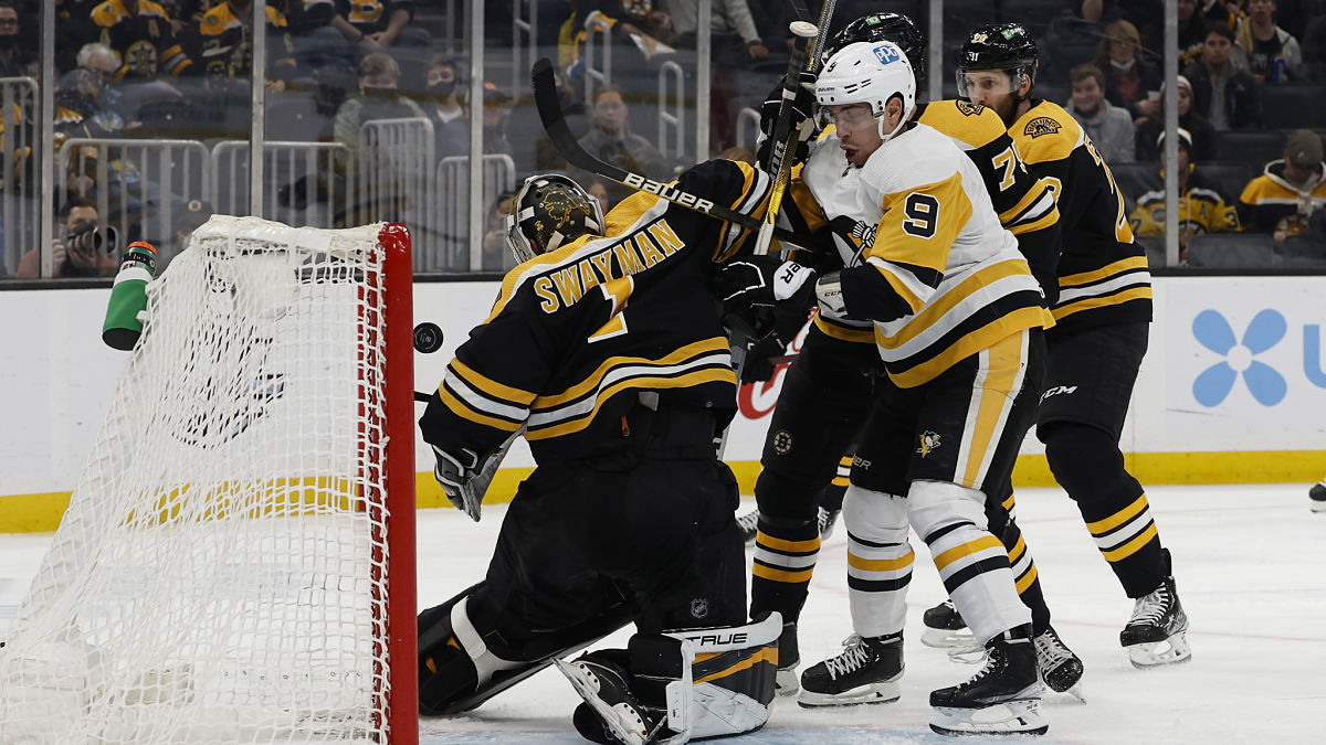 Boston Bruins goaltender Jeremy Swayman, center Evan Rodrigues