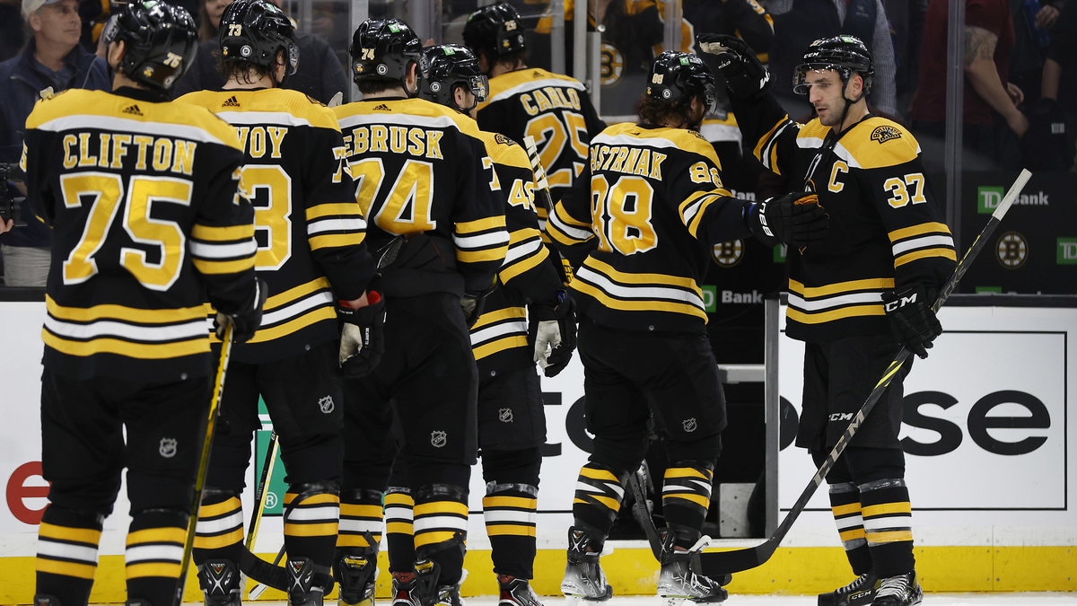 Boston Bruins center Patrice Bergeron and teammates