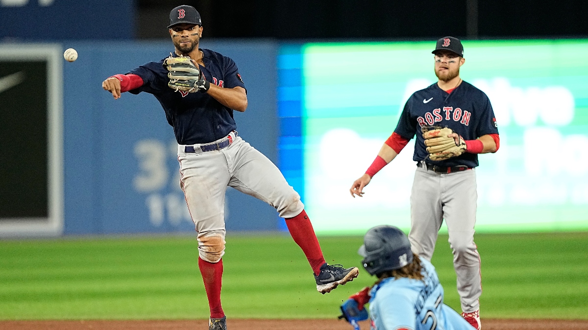 Boston Red Sox shortstop Xander Bogaerts (2) and second baseman Trevor Story, and Toronto Blue Jays first baseman Vladimir Guerrero Jr. (27)