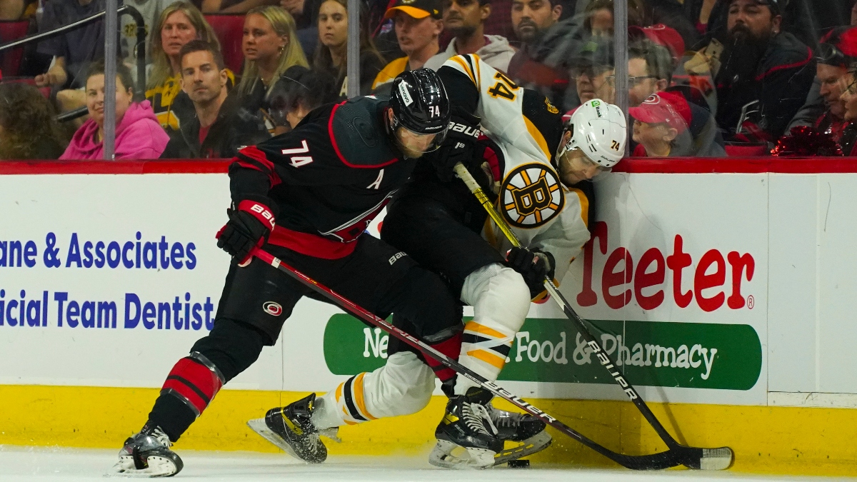 Carolina Hurricanes defenseman Jaccob Slavin (74) and Boston Bruins left wing Jake DeBrusk (74)
