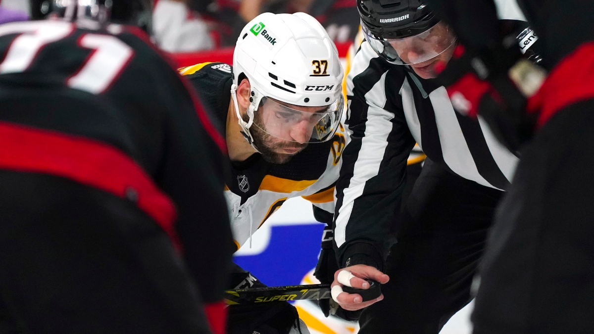 Boston Bruins center Patrice Bergeron (37) watches the puck before face off against the Carolina Hurricanes