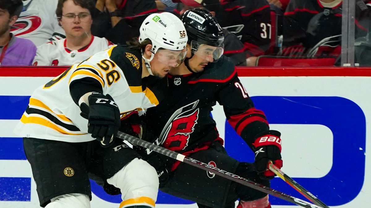 Boston Bruins left wing Erik Haula (56), Carolina Hurricanes center Seth Jarvis (24)