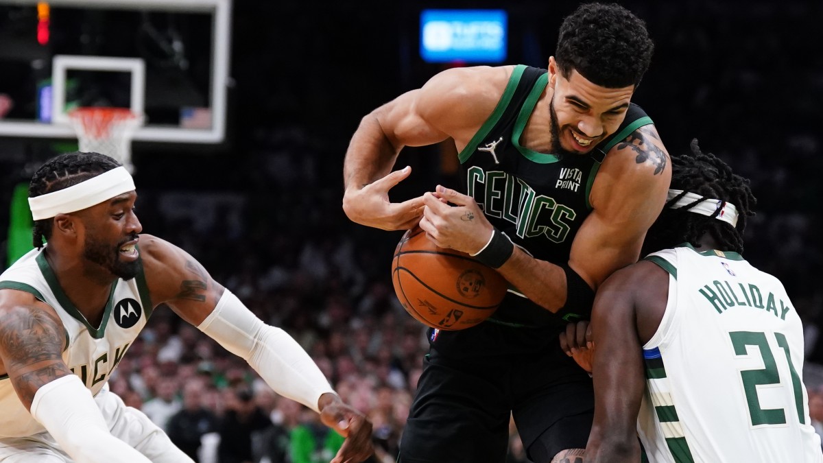 Boston Celtics forward Jayson Tatum (0), Milwaukee Bucks guard Jrue Holiday (21)