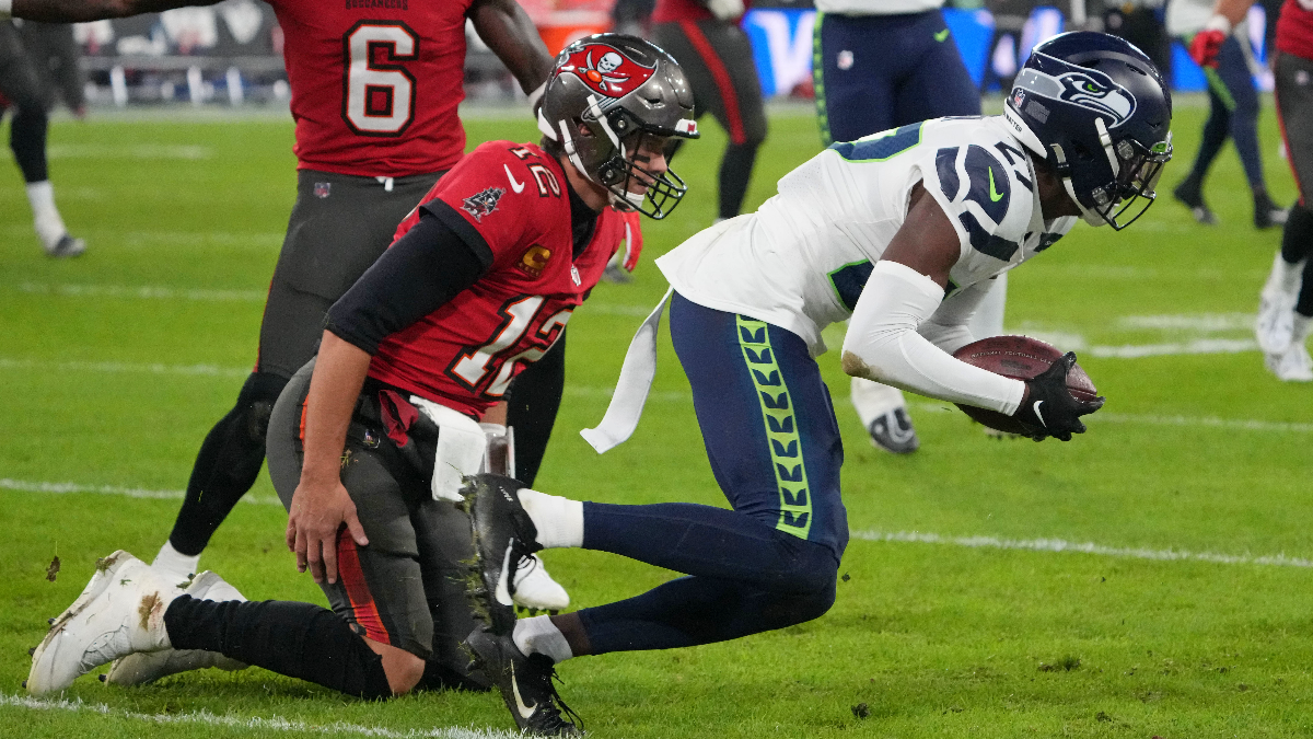 Tampa Bay Buccaneers quarterback Tom Brady and Seattle Seahawks cornerback Tariq Woolen