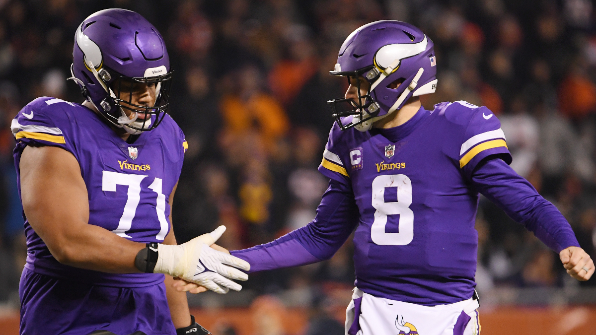 Minnesota Vikings offensive lineman Christian Darrisaw, quarterback Kirk Cousins